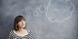 woman with thought bubble on chalk board