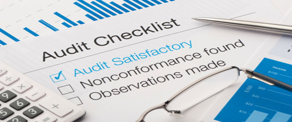 Audit checklist on a desk, with tick against audit satisfactory