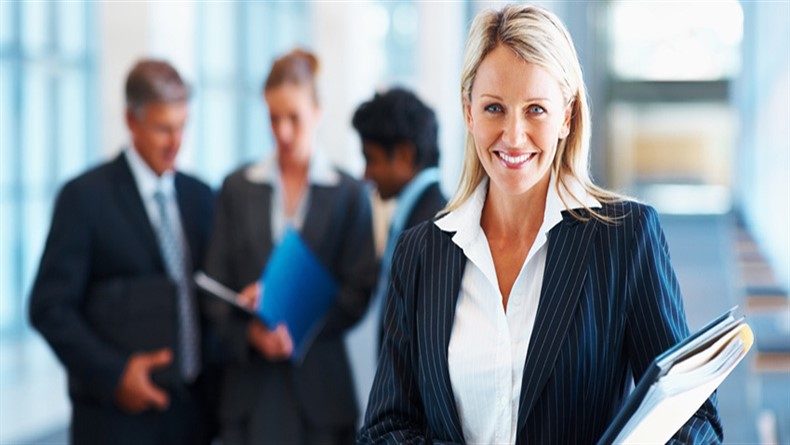 Cute business woman with colleagues in discussion at the background