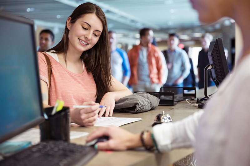 Young students registering for classes at college campus