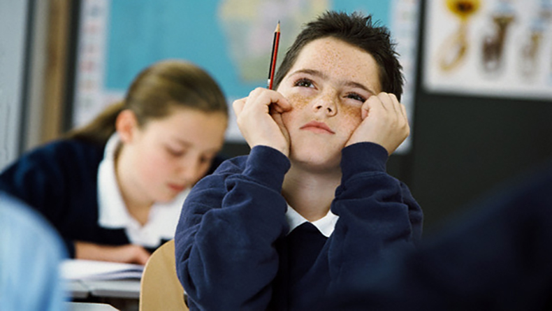 Young Student Thinking in Class --- Image by © Corbis