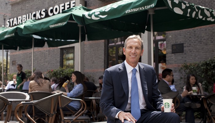 Howard Schultz, chief executive officer of Starbucks Corp. poses for a photograph outside one of the company's coffee shops in Shanghai, China, on Tuesday, April 26, 2011. Schultz said the coffee-shop operator is developing a wider range of ready-made food and beverages after it sold more Via instant coffee than expected. Photographer: Kevin Lee/Bloomberg *** Local Caption *** Howard Schultz