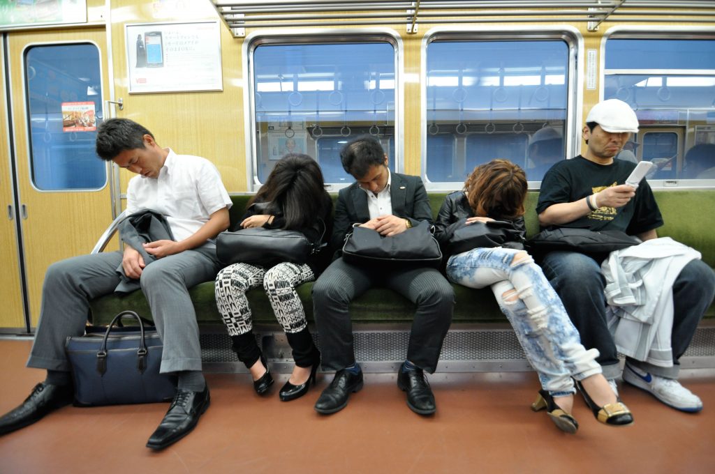 DDWN83 Four people asleep on a train in Japan.. Image shot 2010. Exact date unknown.