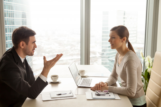 businessman-businesswoman-discussing-work-office-desk_1163-5351