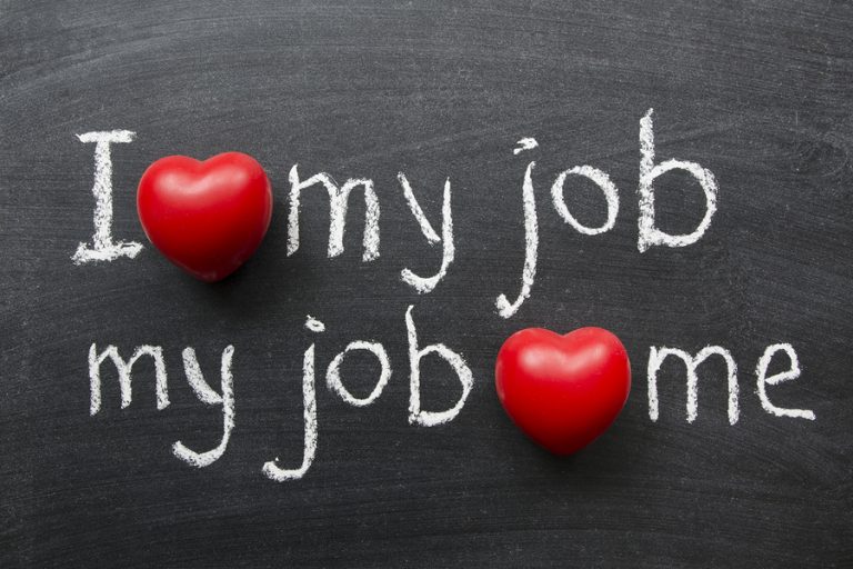 I love my job - positive concept handwritten on black chalkboard with volume red heart symbol