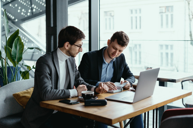 two-young-businessman-having-successful-meeting-restaurant_158595-5332